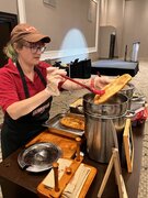 A  woman prepares Beaver Tails pastry at the WordCamp Canada 2024 after party.