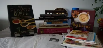 collection of cookbooks and recipes printed from the internet