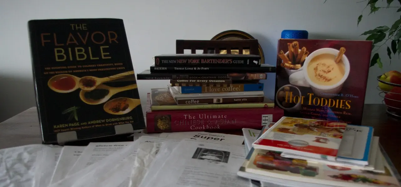 collection of cookbooks and recipes printed from the internet